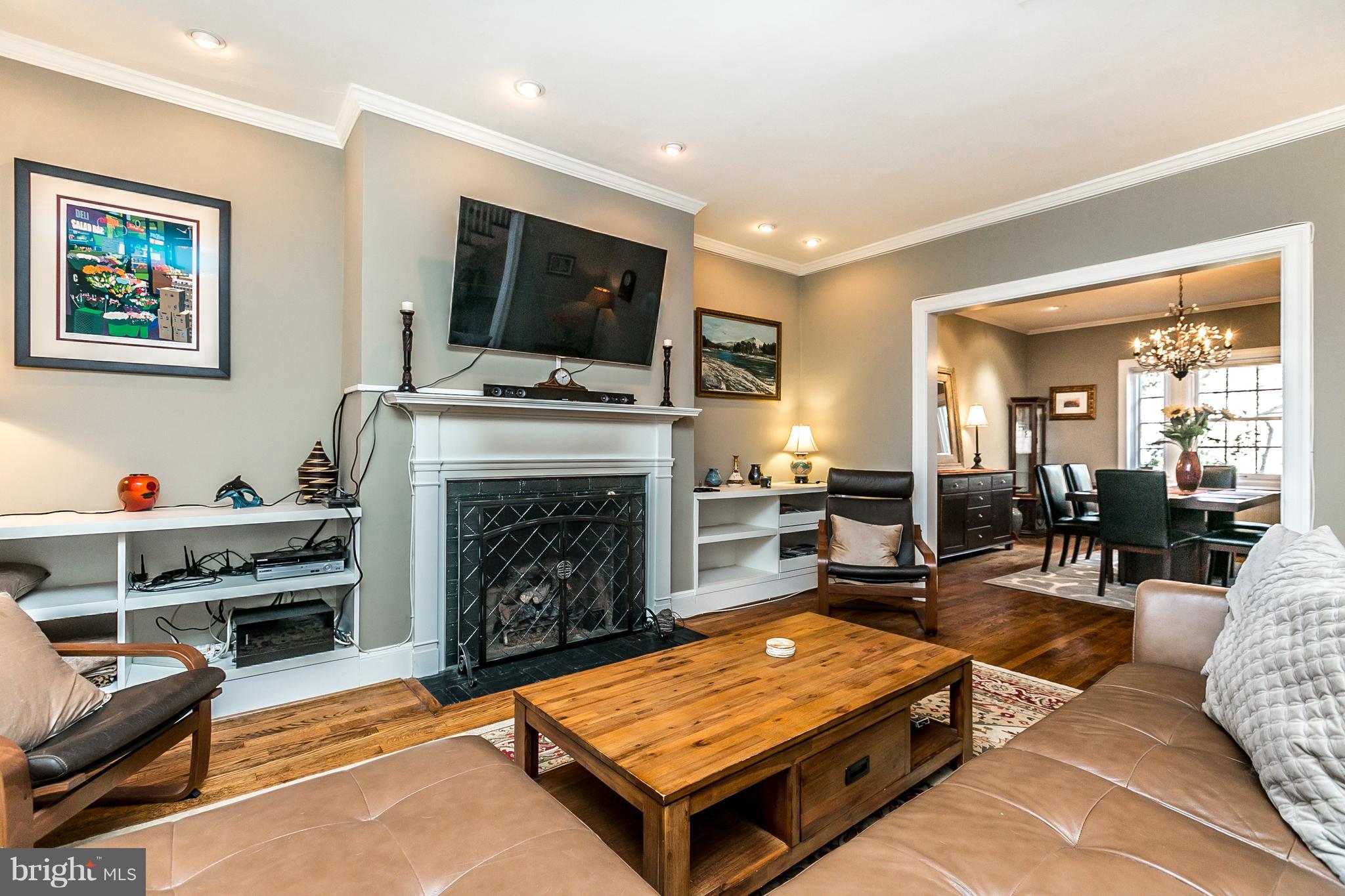 4223 Wickford Road Baltimore, MD 21210 - Photo 5 of 36 a living room with furniture a flat screen tv and a fireplace
