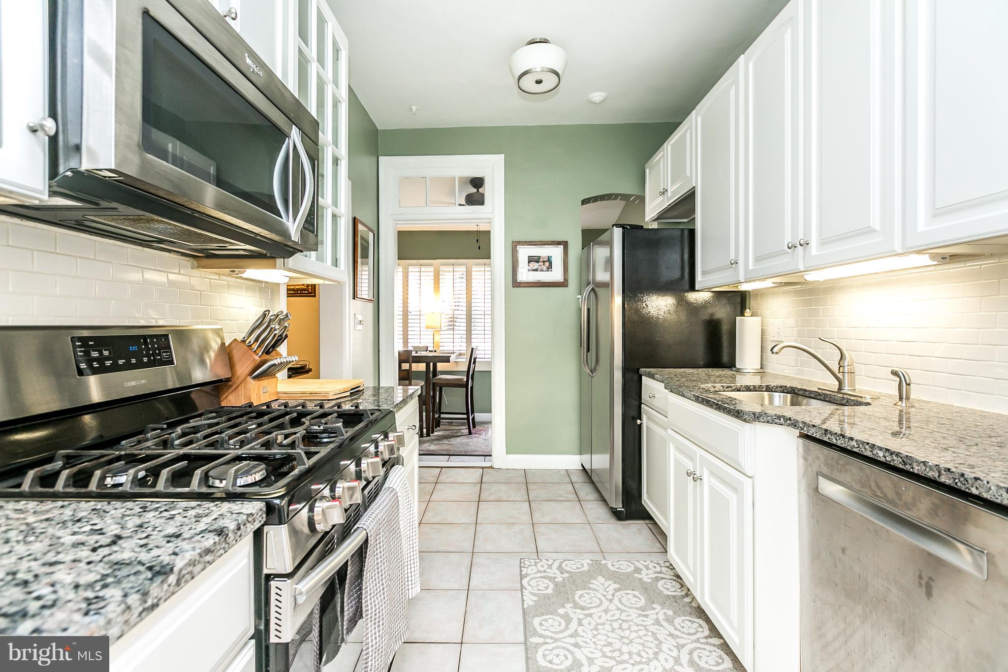 4223 Wickford Road Baltimore, MD 21210 - Photo 8 of 36 a kitchen with stainless steel appliances granite countertop a stove and a microwave