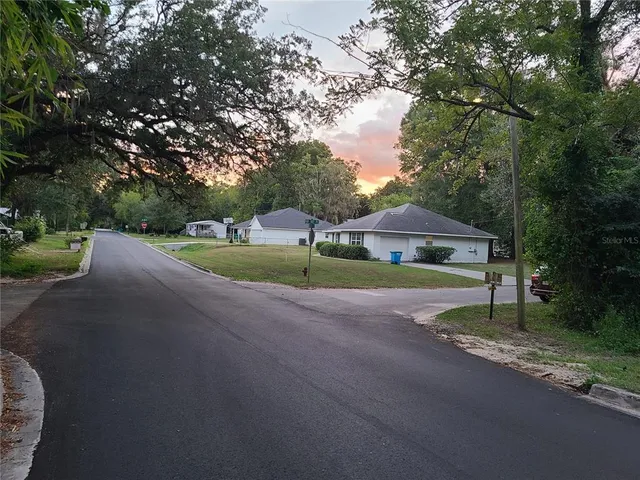 a view of a street with houses on both side