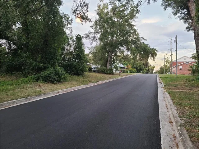 a view of a field with trees in background