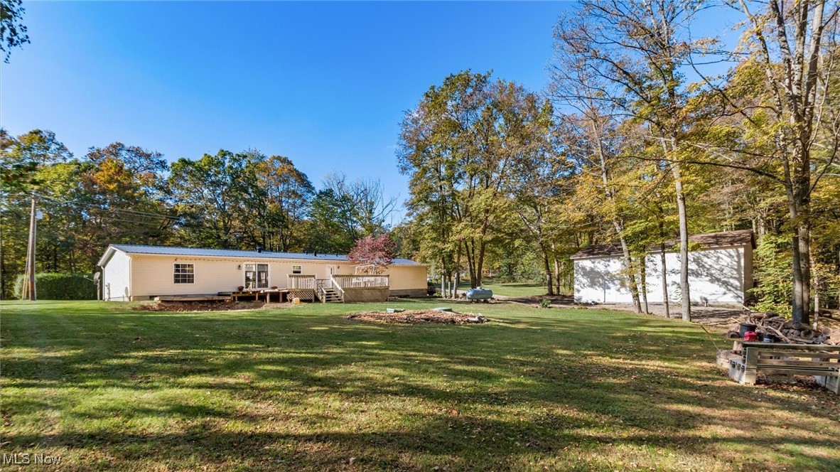 13306 Fairview Road Southeast Newark, OH 43056 - Photo 40 of 48 View of grassy yard featuring a wooden deck and view of wooded area
