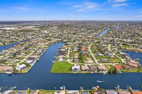 an aerial view of a residential houses with yard and swimming pool