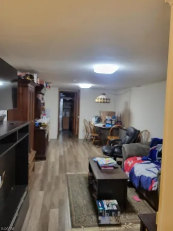 a living room with furniture a ceiling fan and a window