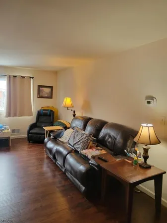 a living room with furniture and a lamp