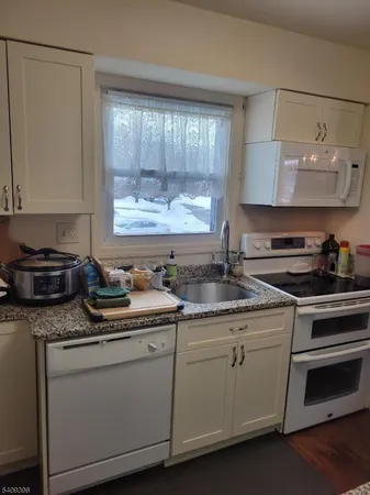 a kitchen with a sink stove and cabinets