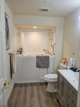 a bathroom with a sink toilet and a mirror