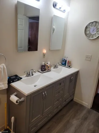 a bathroom with a double vanity sink and a mirror