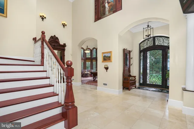 a living room with furniture a fireplace and a large window