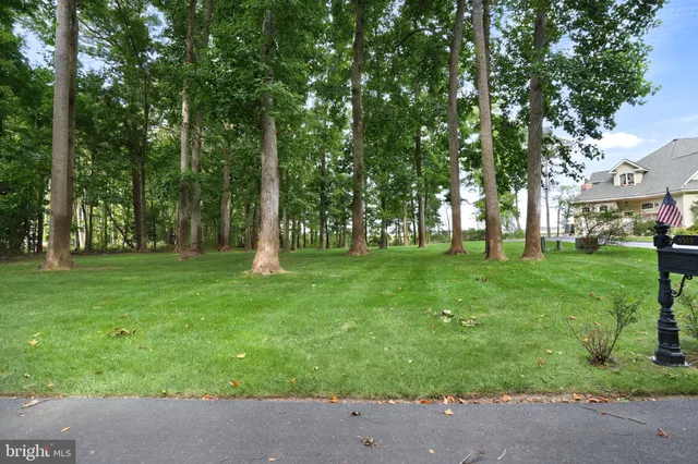 a dining room with chandelier and wooden floor