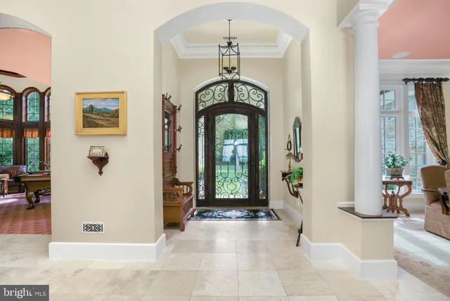 a living room with furniture a rug and a chandelier