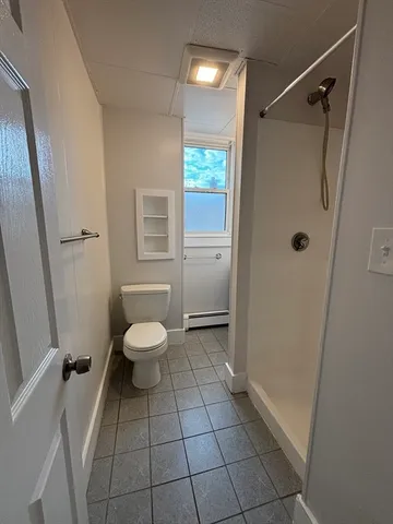 a bathroom with a toilet and a shower