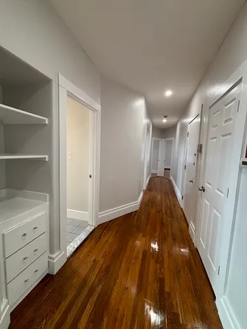 a view of hallway with wooden floor