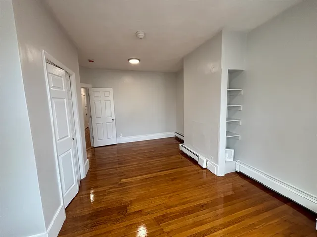 a view of wooden floor and closet in a room