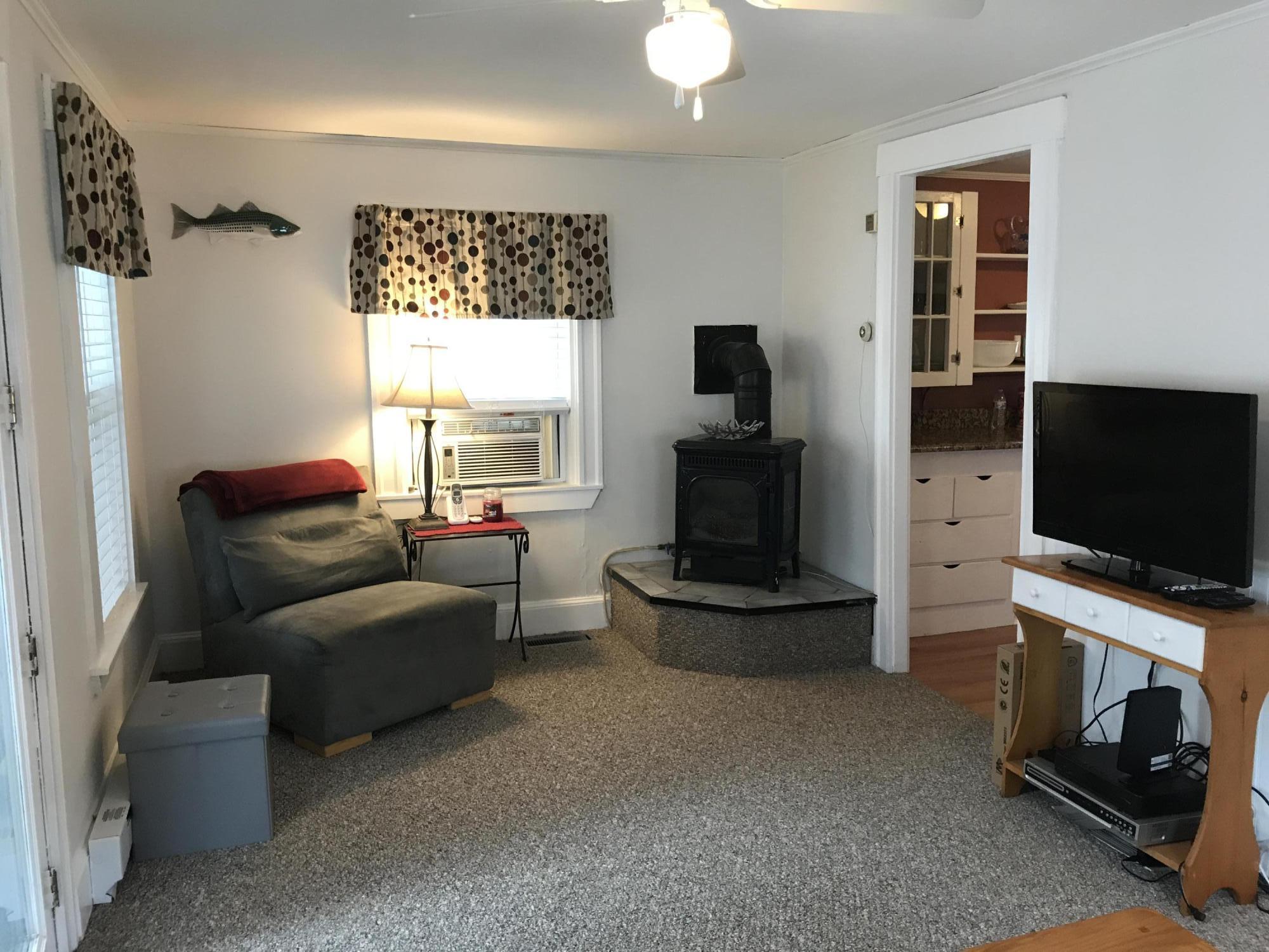 31 Agawam Beach Road Wareham, MA 02571 - Photo 8 of 14 a living room with furniture and a flat screen tv