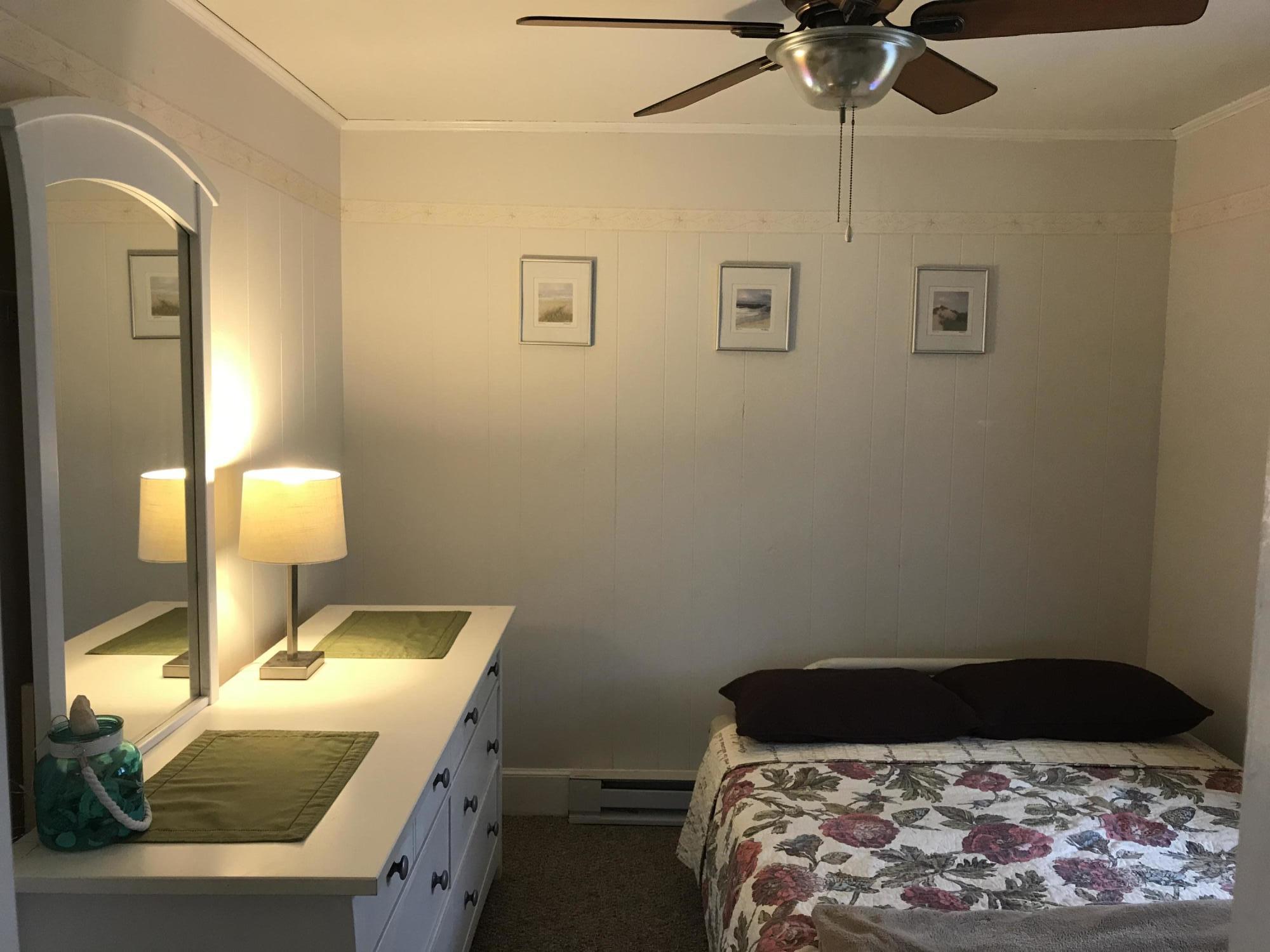 31 Agawam Beach Road Wareham, MA 02571 - Photo 9 of 14 a bedroom with a bed and a lamp