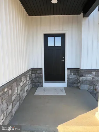 a hallway with sliding door and stairs