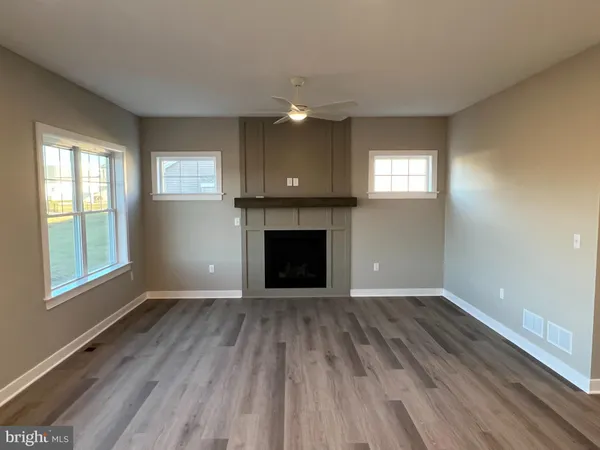 a view of kitchen with wooden floor and electronic appliances