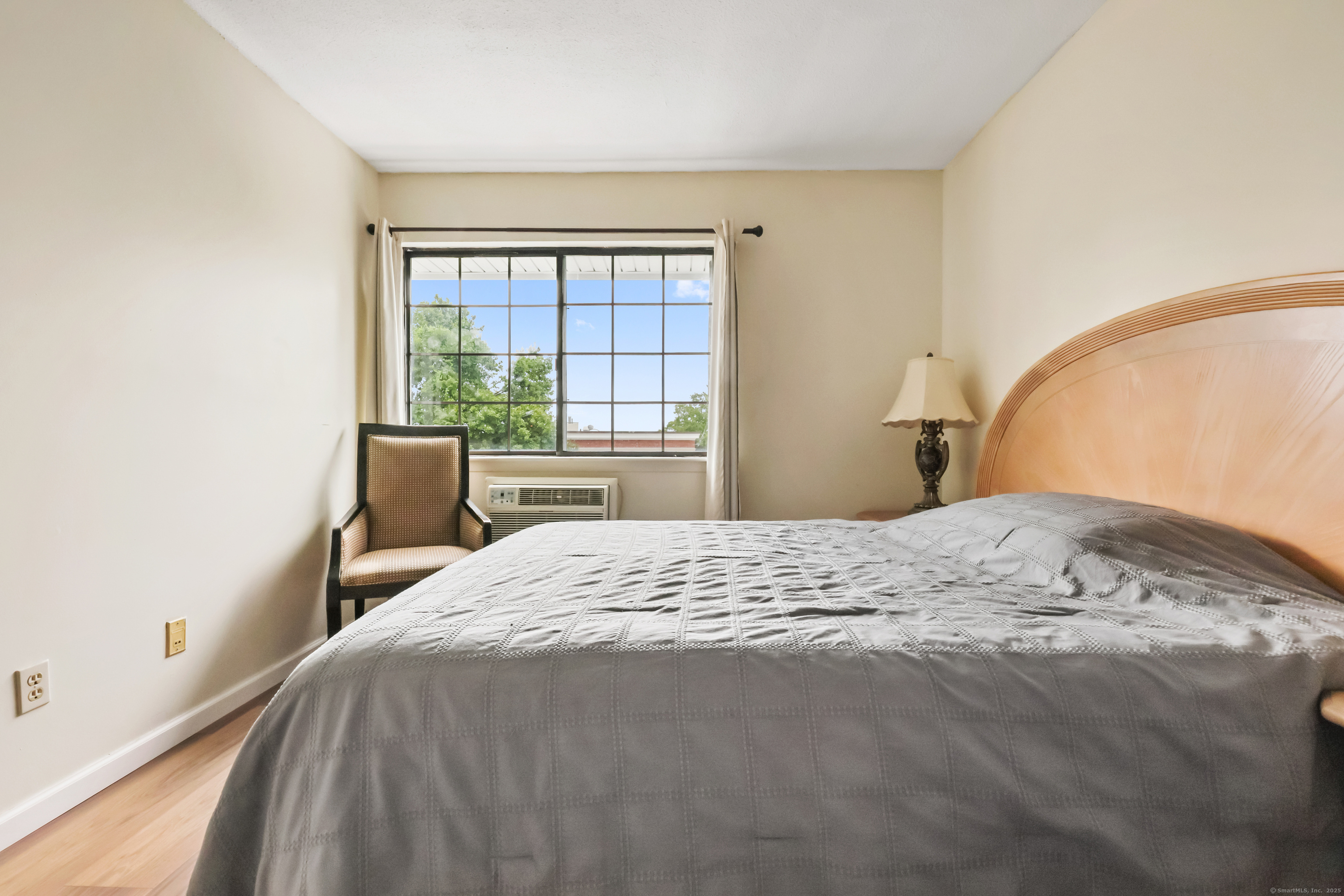 187 Flax Hill Road, Unit D5 Norwalk, CT 06854 - Photo 13 of 19 a bedroom with a bed and a large window