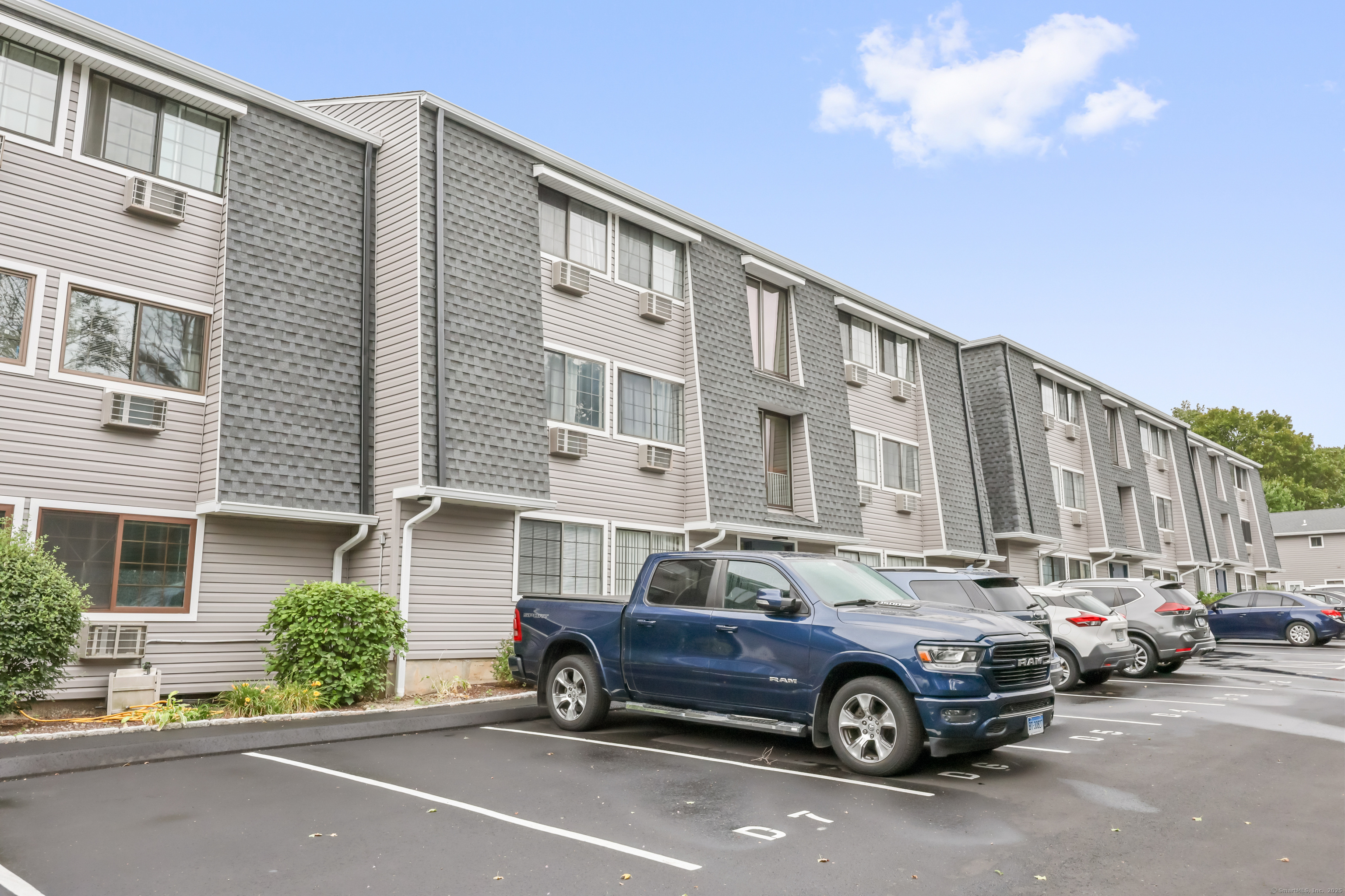 187 Flax Hill Road, Unit D5 Norwalk, CT 06854 - Photo 17 of 19 a car parked in front of a house