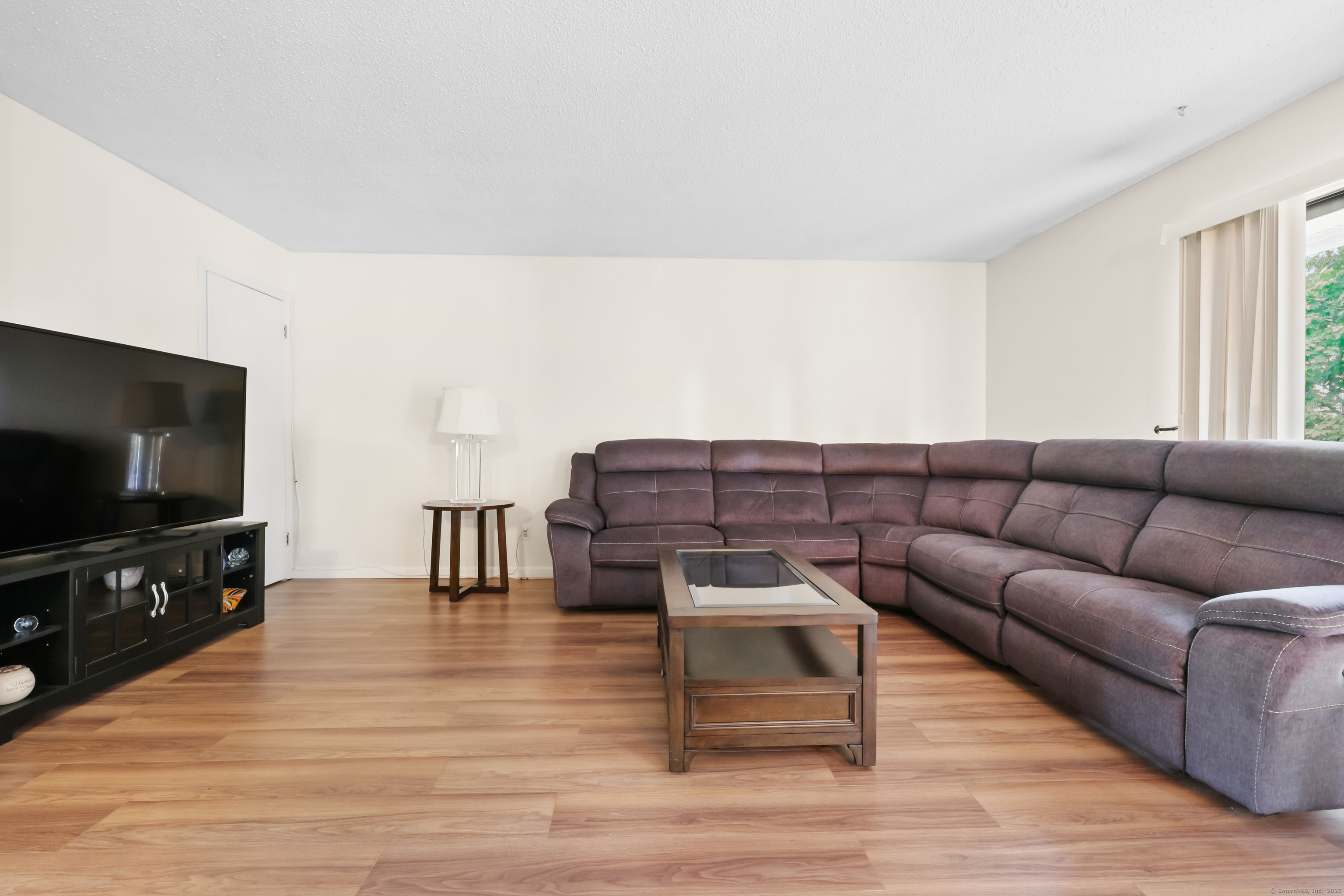187 Flax Hill Road, Unit D5 Norwalk, CT 06854 - Photo 5 of 19 a living room with furniture and a flat screen tv