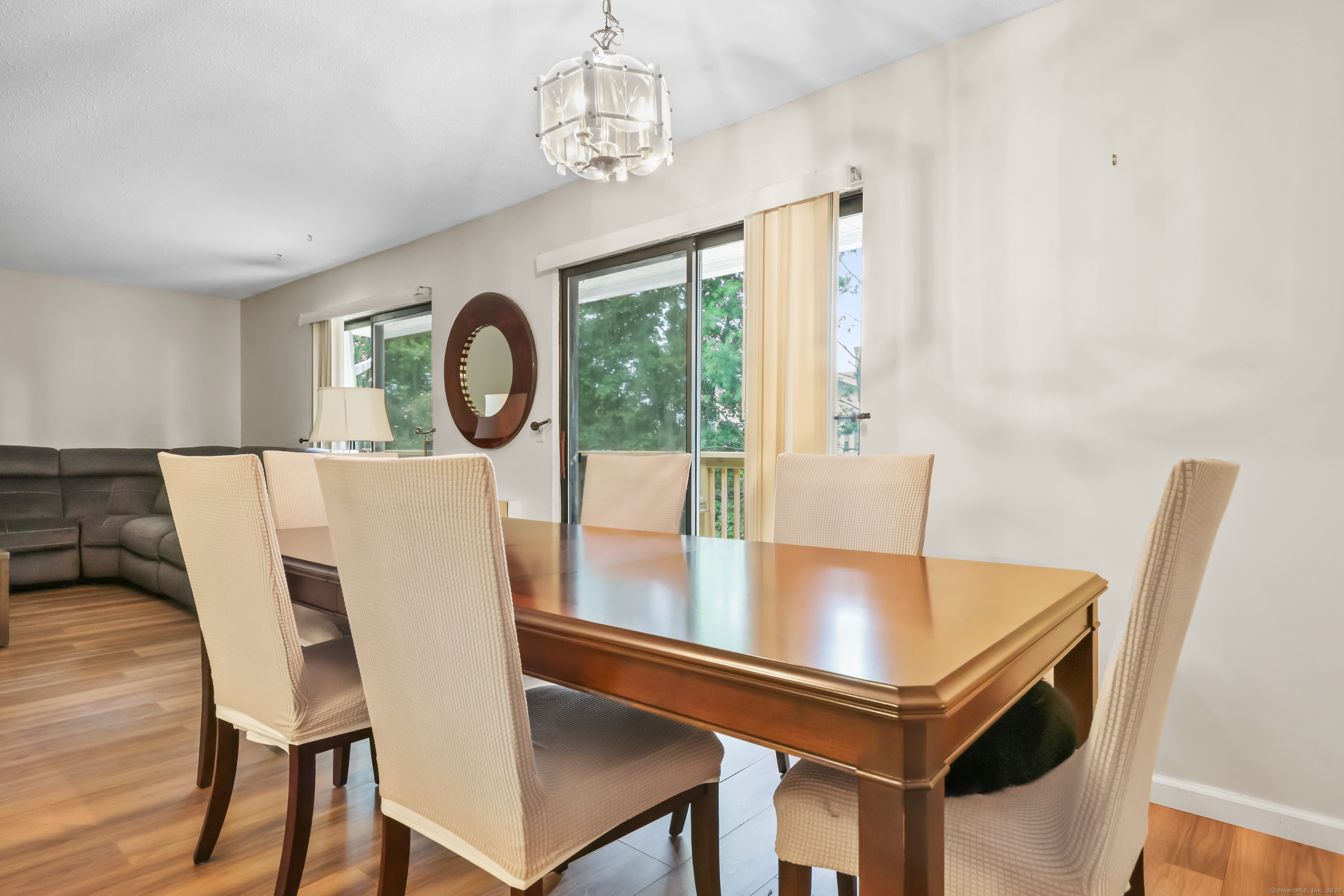 187 Flax Hill Road, Unit D5 Norwalk, CT 06854 - Photo 7 of 19 a view of a dining room with furniture and a chandelier