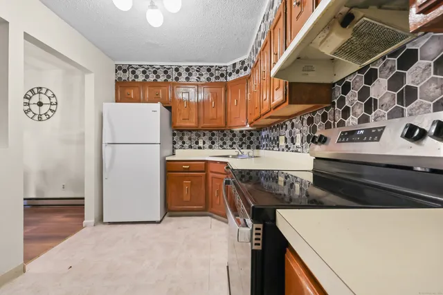 a kitchen with a refrigerator and a stove