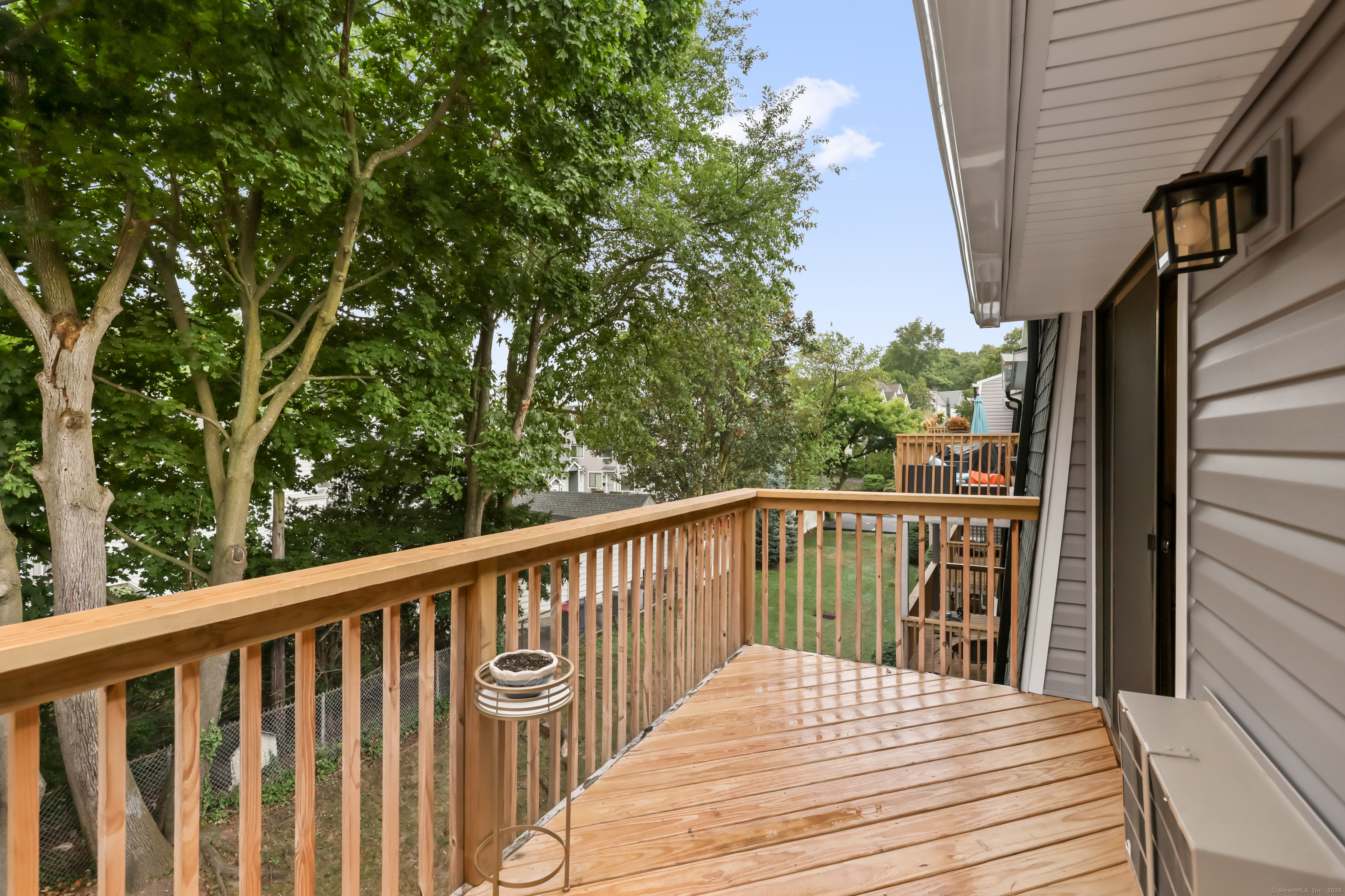 187 Flax Hill Road, Unit D5 Norwalk, CT 06854 - Photo 10 of 19 a balcony with wooden floor and fence