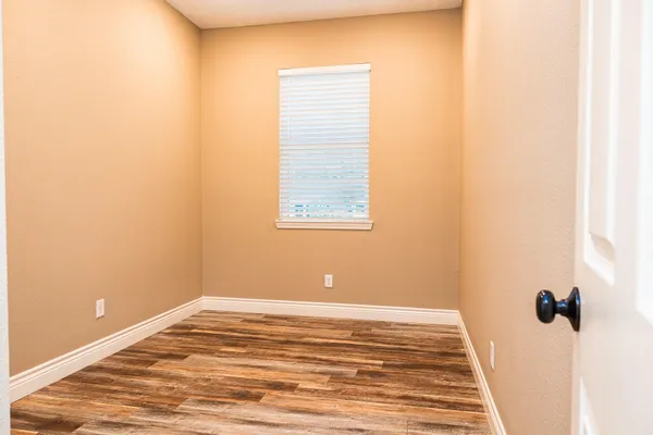 a view of a room with wooden floor and cabinet