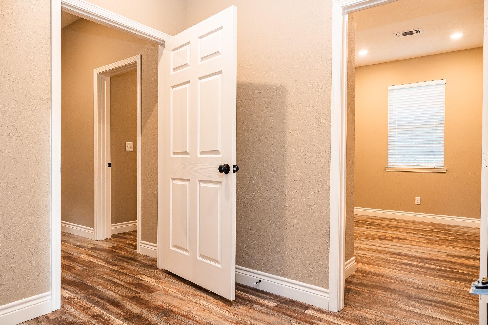1306 South Austin Street Brenham, TX 77833 - Photo 12 of 16 a view of a bathroom with wooden floor