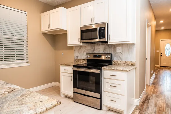 a kitchen with a stove and a microwave