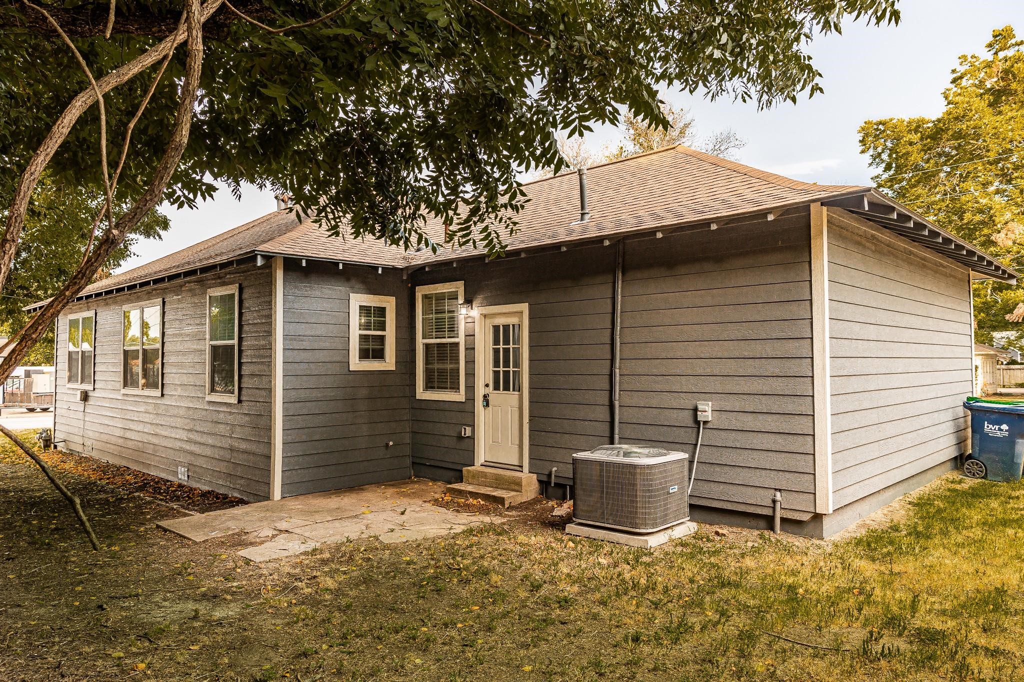 1306 South Austin Street Brenham, TX 77833 - Photo 15 of 16 a view of a small house with yard and garage