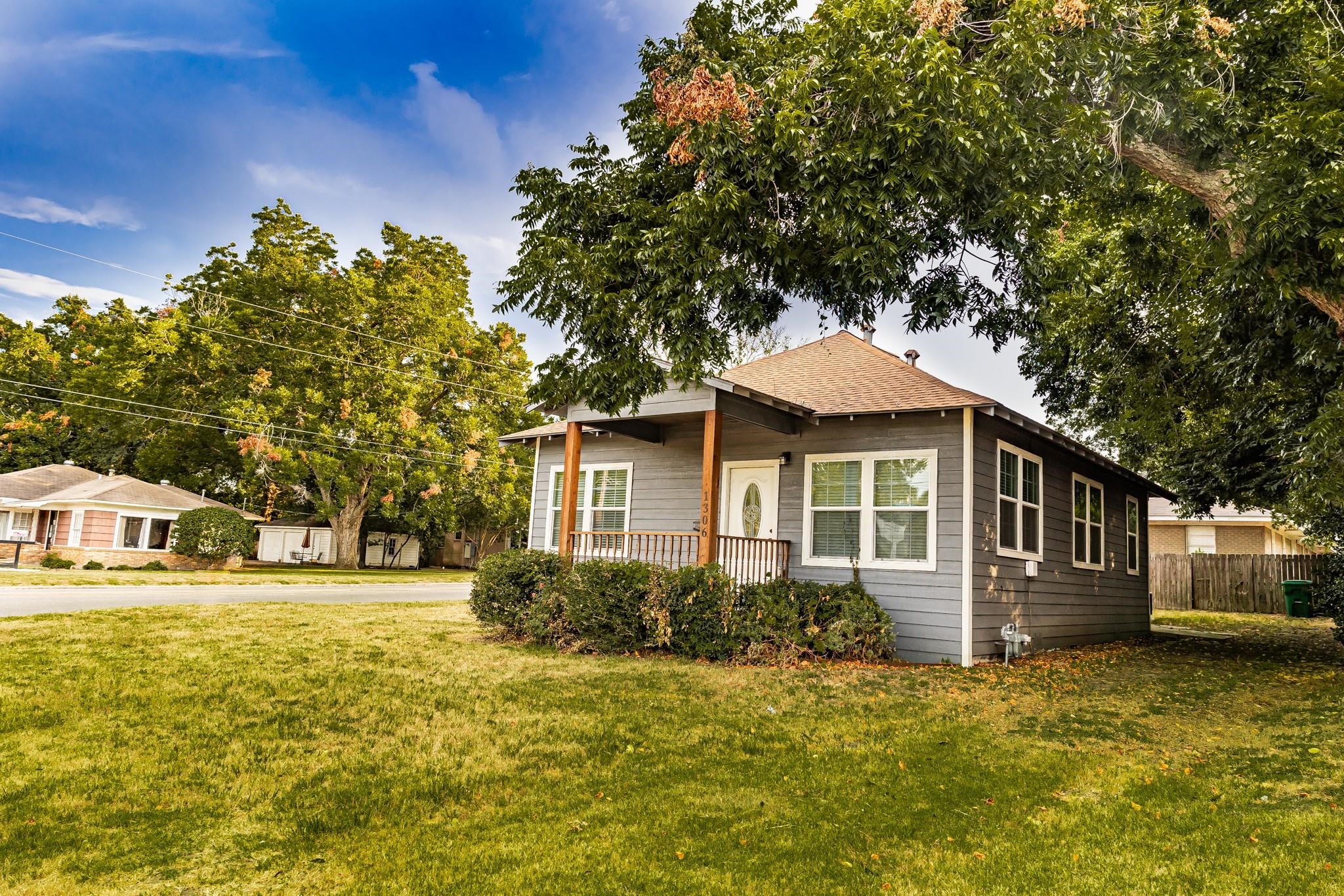 1306 South Austin Street Brenham, TX 77833 - Photo 16 of 16 a front view of a house with a yard and trees
