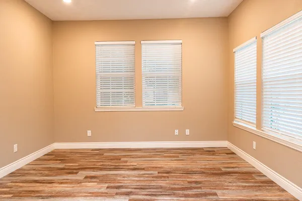 a view of a room with wooden floor and a window