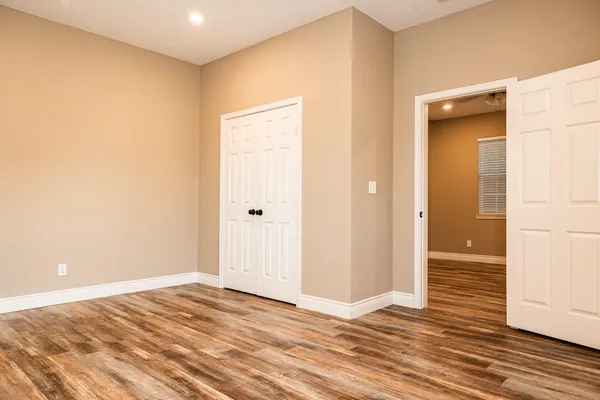 a view of a livingroom with wooden floor and closet