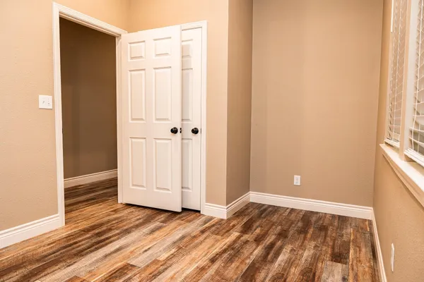 a view of a room with wooden floor and bathroom