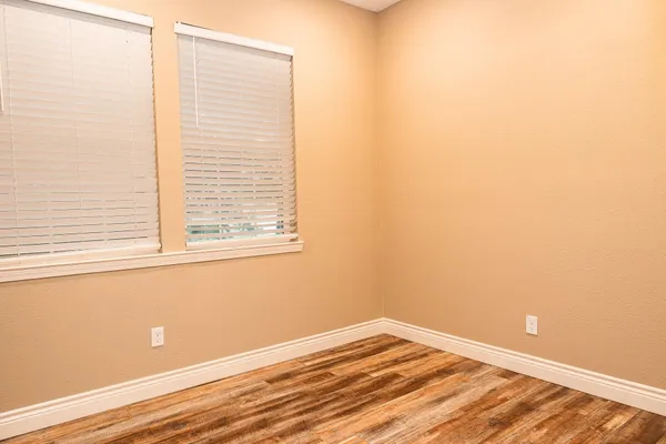 a view of a room with wooden floor and fan
