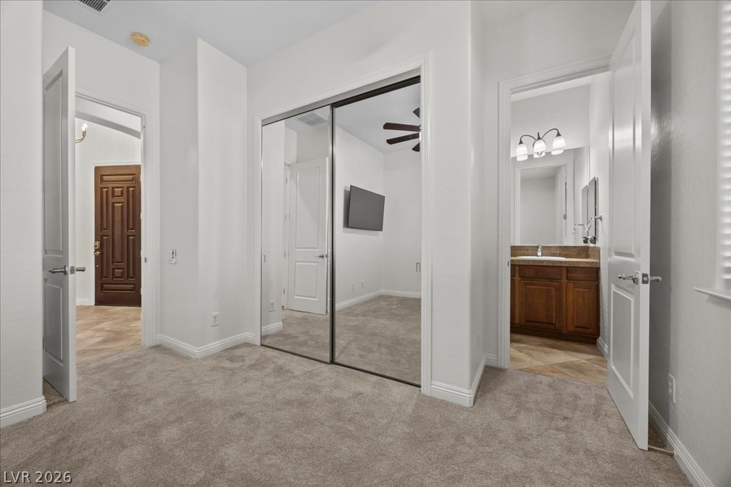 2125 De Rouge Avenue Henderson, NV 89044 - Photo 63 of 96 Reflective mirrored closet doors complement the plush carpet flooring in this versatile interior space.