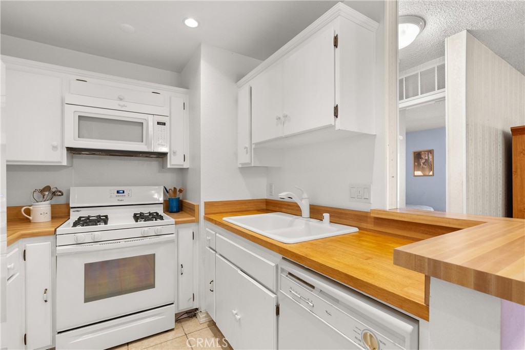 12620 Briarglen Loop, Unit K Stanton, CA 90680 - Photo 15 of 28 Built-in microwave above the gas range.