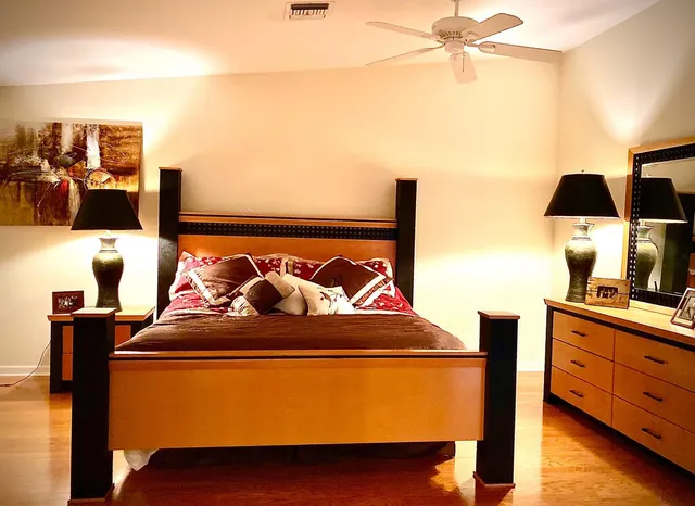 a spacious bathroom with a double vanity sink a mirror and a toilet