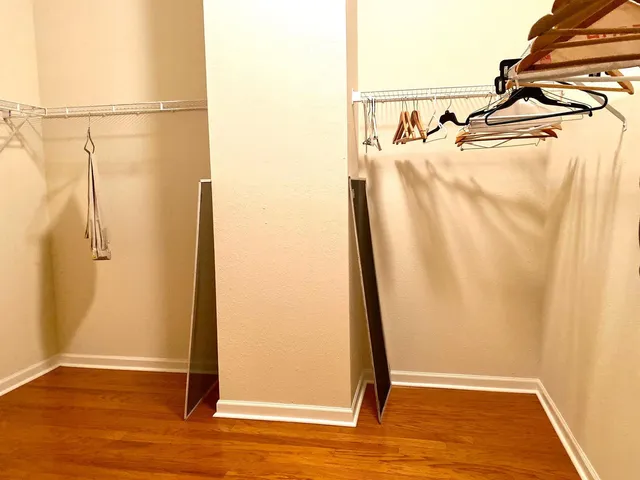 a bedroom with two beds and painting on the wall