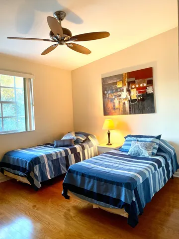 a bedroom with two beds and a chandelier