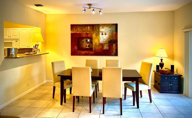 a view of a living room with furniture and a lamp