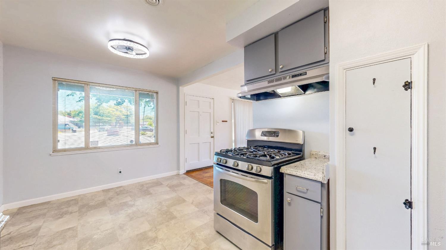 809 Maple Avenue Vallejo, CA 94591 - Photo 13 of 46 a kitchen with stainless steel appliances granite countertop a stove and a cabinet