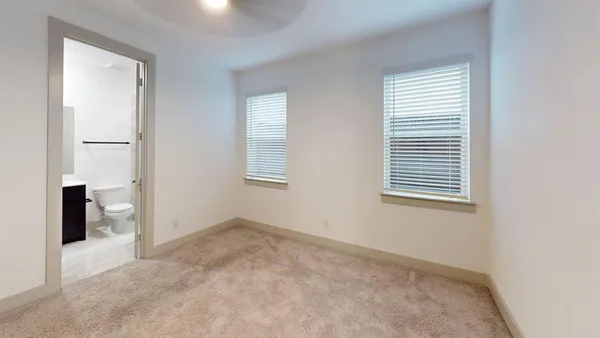 an empty room with windows and closet