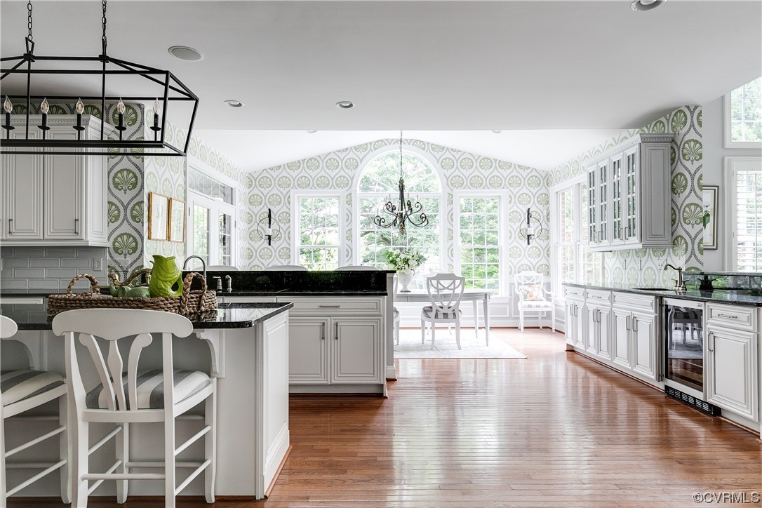 508 Raleigh Manor Road Henrico, VA 23229 - Photo 11 of 25 a kitchen with stainless steel appliances granite countertop a stove top oven a sink a dining table and chairs with wooden floor
