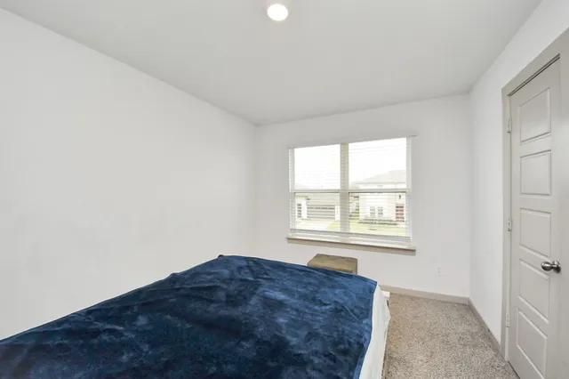 a view of a big room with windows and closet