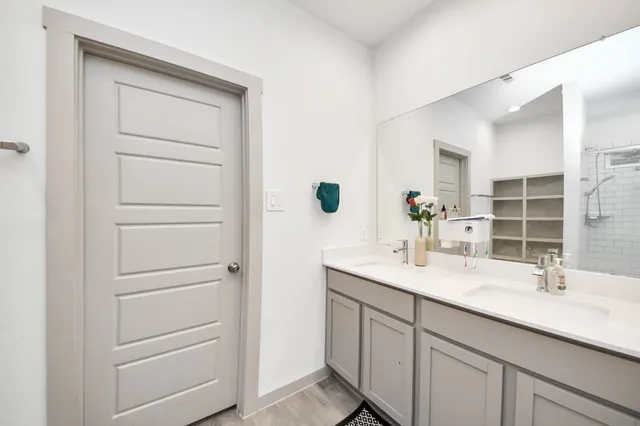 a bathroom with a sink vanity granite and a mirror