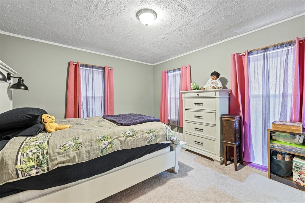 20 Rosseter Street Boston, MA 02121 - Photo 14 of 24 a bedroom with a bed and a window