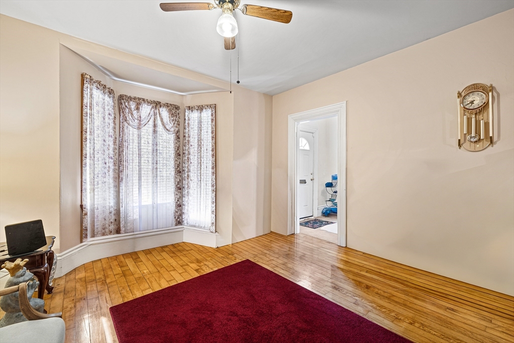20 Rosseter Street Boston, MA 02121 - Photo 3 of 24 a bedroom with a bed and a chandelier