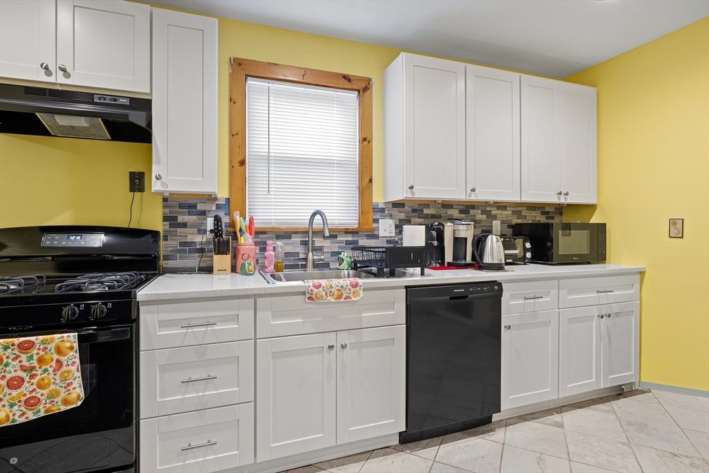 20 Rosseter Street Boston, MA 02121 - Photo 7 of 24 a kitchen with white cabinets and appliances